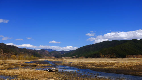Scenic view of mountains against cloudy sky
