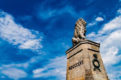 Low angle view of statue against sky