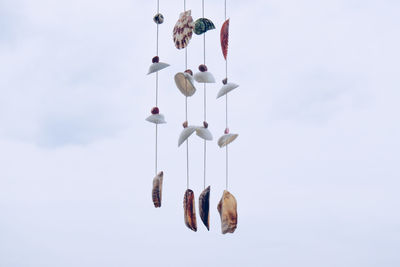 Low angle view of flags hanging against sky