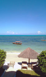 Scenic view of sea and beach against blue sky