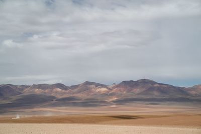 View of a desert against cloudy sky