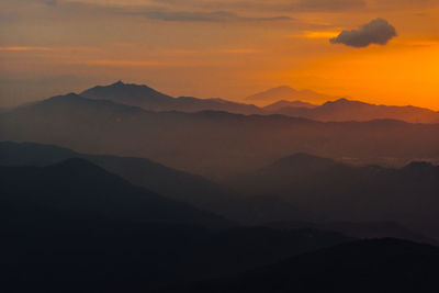 Scenic view of silhouette mountains against sky during sunset