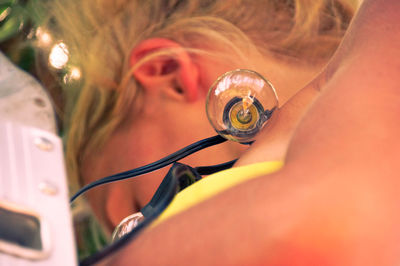 Close-up portrait of woman holding eyeglasses