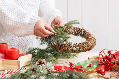 Midsection of woman holding christmas tree