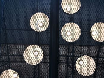 Low angle view of illuminated light bulbs hanging from ceiling