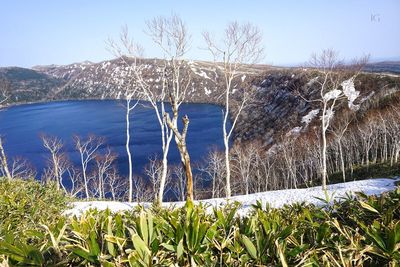 View of snow covered landscape against blue sky