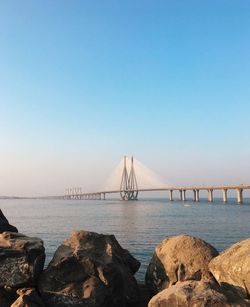 View of bridge over sea against clear sky