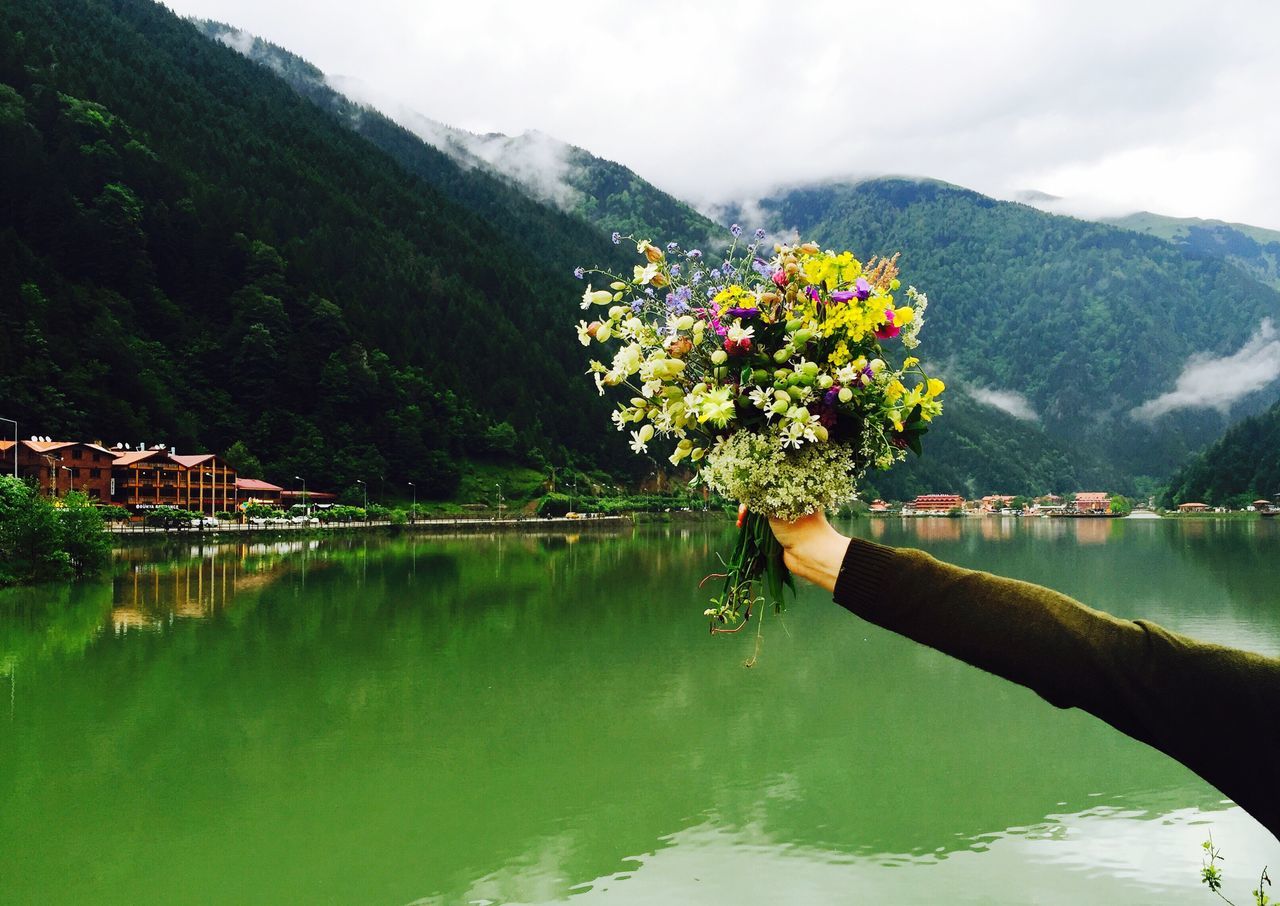 mountain, reflection, water, tree, lake, scenics, tranquil scene, tranquility, built structure, waterfront, cloud - sky, multi colored, beauty in nature, nature, vacations, day, town, sky, tourism, standing water, non-urban scene, mountain range, no people, surrounding