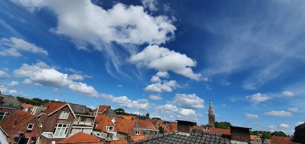 Low angle view of buildings against cloudy sky