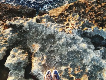 Low section of person standing on rock