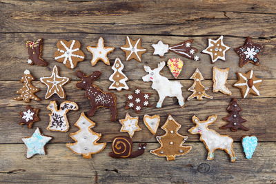 High angle view of gingerbread cookies arranged on wooden table