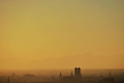 Buildings against clear orange sky during sunset