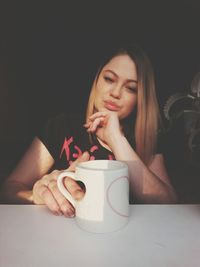 Close-up of woman holding coffee cup