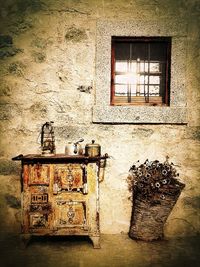 Rusty window on abandoned wall