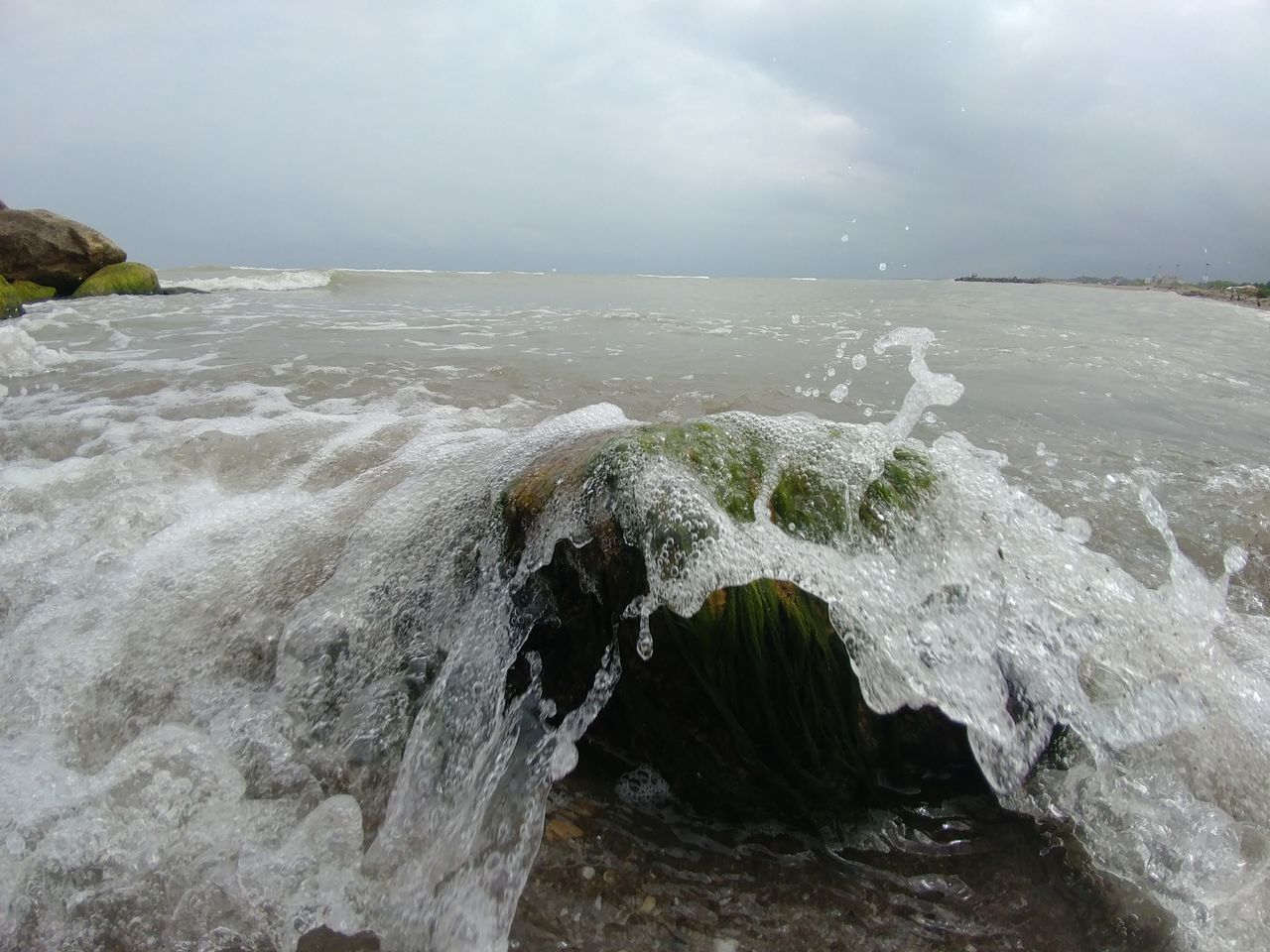 SEA WAVES SPLASHING ON ROCKS