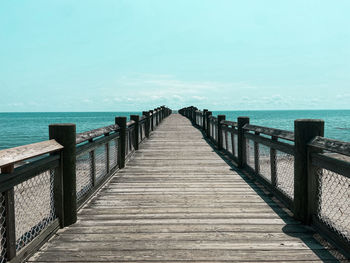 Pier over sea against sky