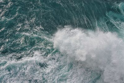 High angle view of waves splashing in sea