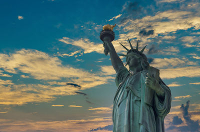 Low angle view of statue against cloudy sky