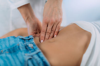 Pediatrician gastroenterologist, examining preschooler boys abdomen.