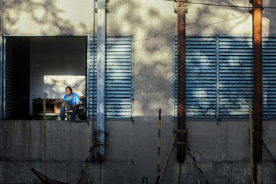 Full length of woman standing in front of building