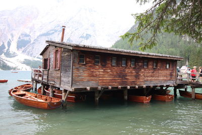Boat in river against houses