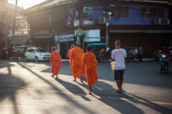 PEOPLE WALKING ON STREET IN CITY