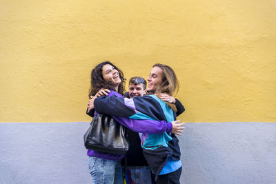 Young diverse friends talking outdoors on the street.