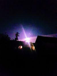 Low angle view of illuminated building against sky at night