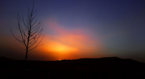 Scenic view of silhouette landscape against sky at sunset