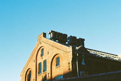 Low angle view of temple against clear blue sky