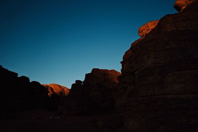 Low angle view of rock formations against blue sky