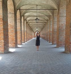 Full length rear view of man standing in corridor