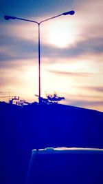 View of street light against sky at sunset