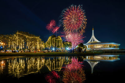 Low angle view of firework display at night