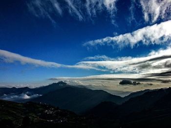 Scenic view of mountains against cloudy sky