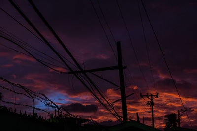 Silhouette electricity pylon against sky during sunset