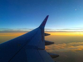 Cropped image of airplane flying over sea