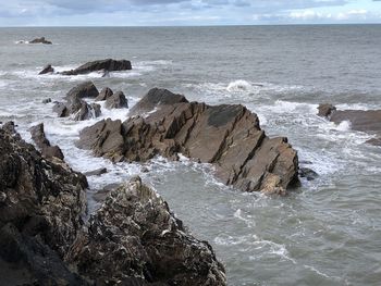 Rocks on beach against sky