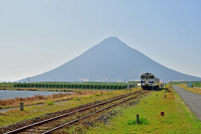 Train on railroad track against sky