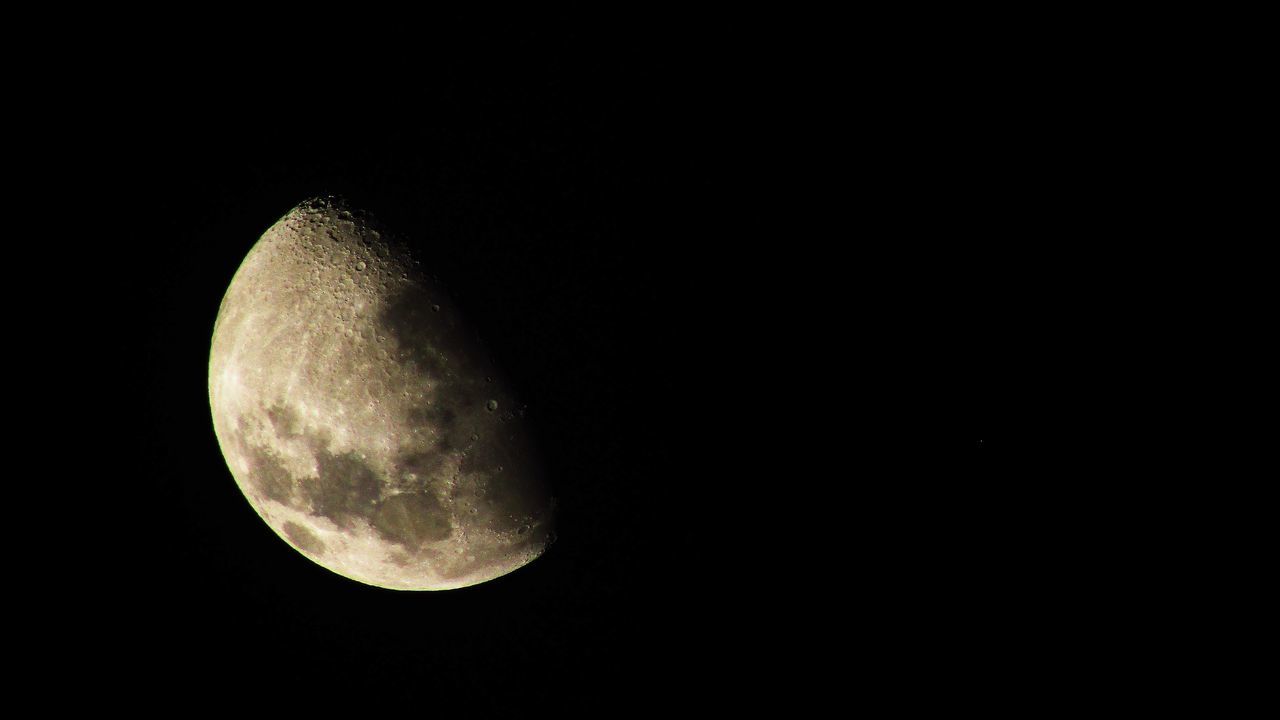 LOW ANGLE VIEW OF MOON AGAINST DARK SKY