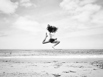 Woman on beach against sky