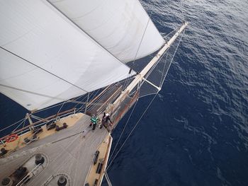 High angle view of people on sailboat sailing at sea
