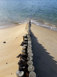 High angle view of wooden posts on beach