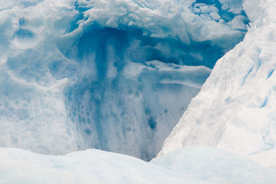 Close-up of frozen landscape against blue sky