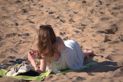 Woman lying down on sand