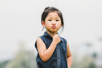 Portrait of cute girl standing outdoors