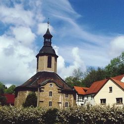Buildings against cloudy sky
