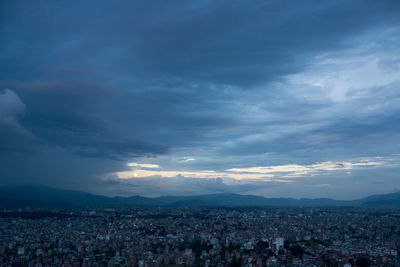 Cityscape against cloudy sky