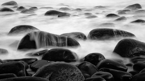 Close-up of pebbles in water