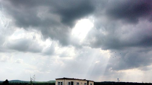 Low angle view of building against cloudy sky
